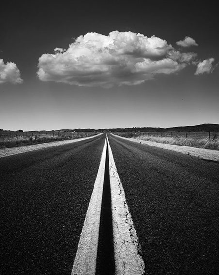 Black and white photo of a street lane and cloud in Ramona, San Diego