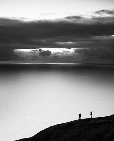 Black and white photo of two people on a cliff in Torrey Pines, San Diego